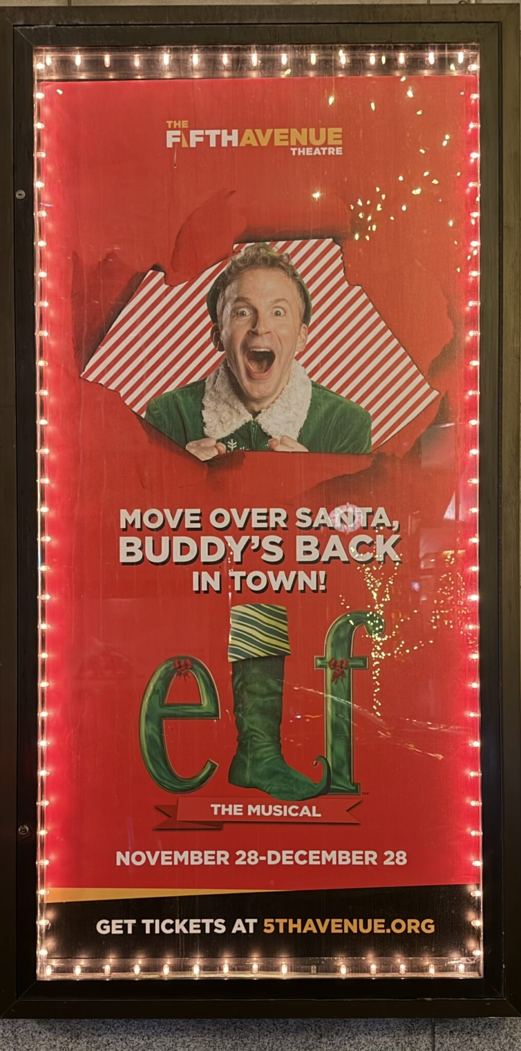 Smiling elf on Elf the Musical poster